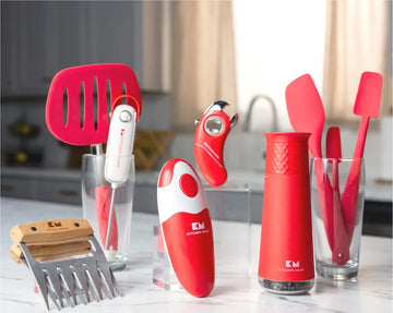 Kitchen Mama product lineup displayed on a countertop, featuring electric can openers, silicone utensils, gravity grinder, meat claws, and bottle opener, with Kitchen Mama logo.